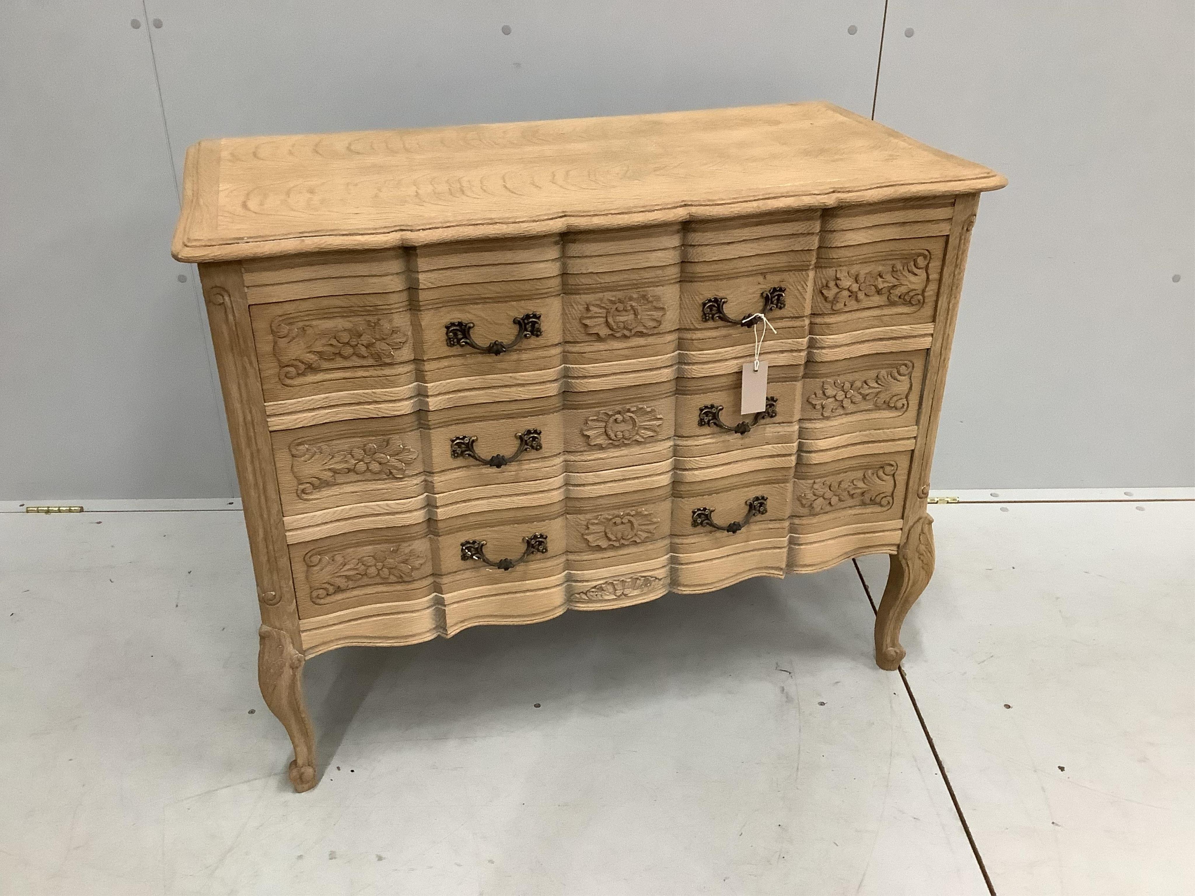 A reproduction bleached oak chest of three drawers, width 99cm, depth 49cm, height 80cm. Condition - good